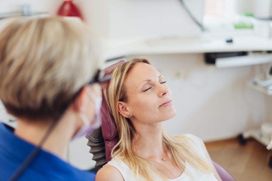 Woman relaxing with her eyes close at the dentist