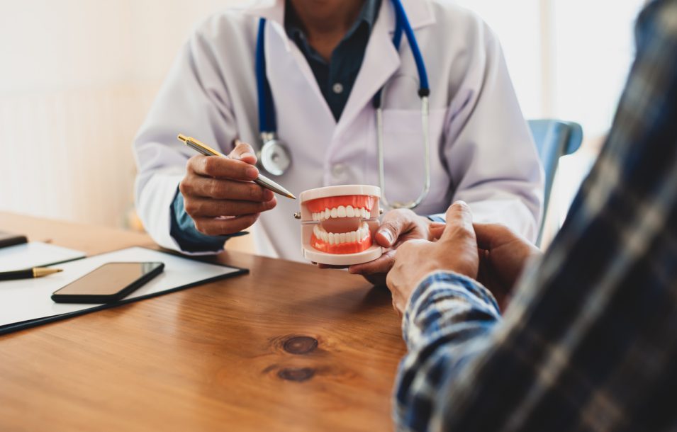 The patient is listening to an explanation from the dentist. Dentists are explaining and giving advice on how to care for your teeth.