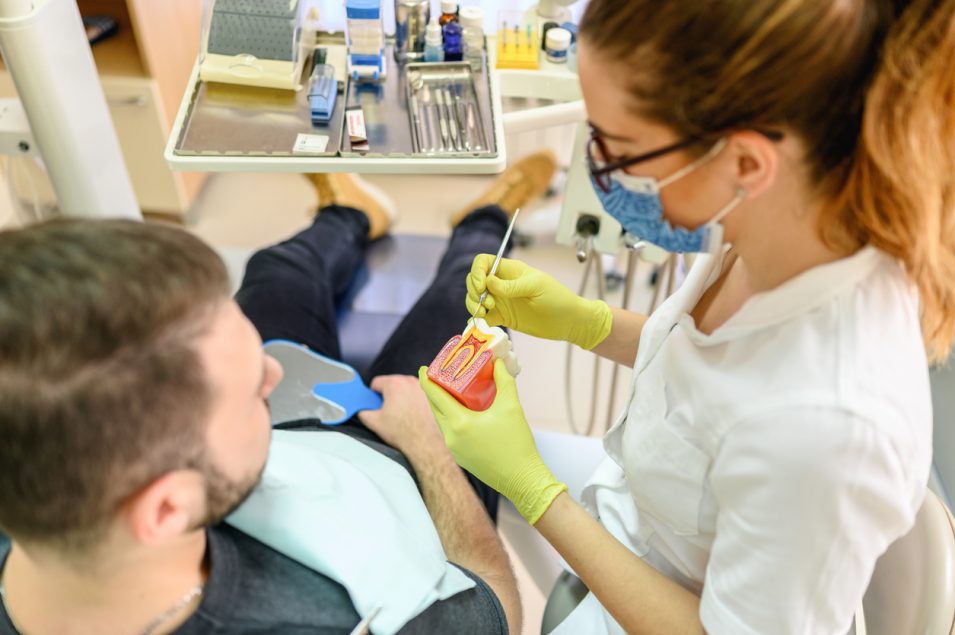 Dentist explaining what dental cavity looks