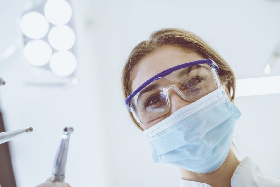 Skillful Young Female Dentist is Treating Patient Teeth