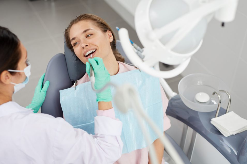 dental hygienist perfroming dental checkup