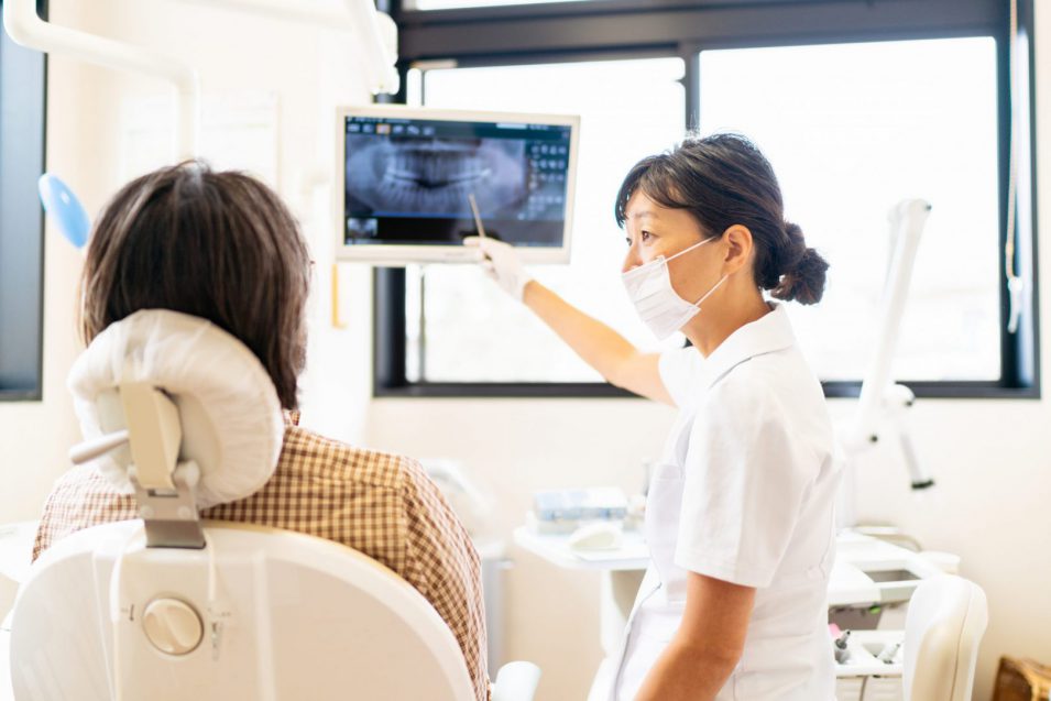 dentist explaining dental x-ray to patient