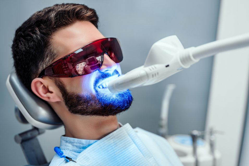 man getting teeth whitening in hamilton dental office