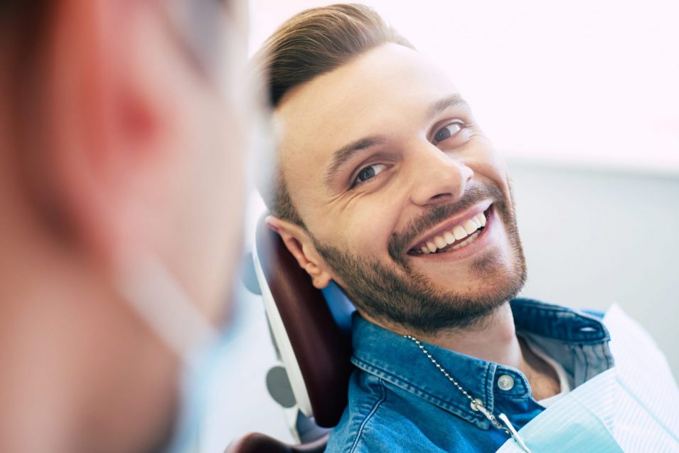 man smiling before oral exam at hamilton dental clinic