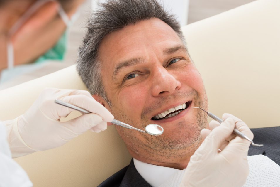 periodontist performing treatment at hamilton clinic