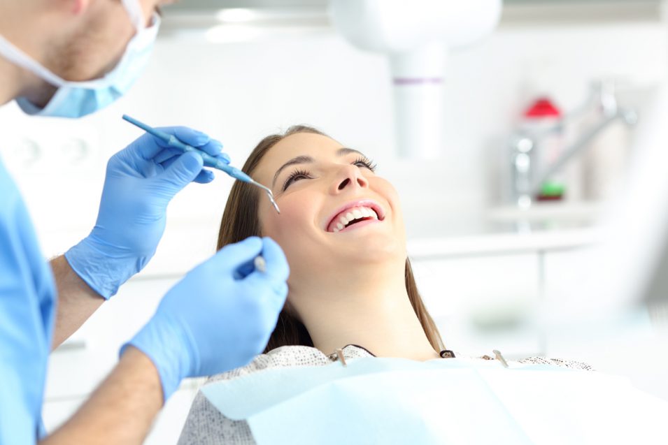 smiling girl at hamilton dentist chair for dental sealants